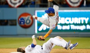 LOS ANGELES, CA - OCTOBER 10: Ruben Tejada #11 of the New York Mets is hit by a slide by Chase Utley #26 of the Los Angeles Dodgers in the seventh inning in an attempt to turn a double play in game two of the National League Division Series at Dodger Stadium on October 10, 2015 in Los Angeles, California. (Photo by Sean M. Haffey/Getty Images)